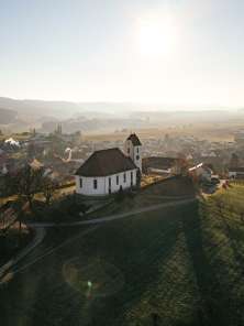 Wilchingen village A church stands on a hill with vines. Behind it you can see the village.