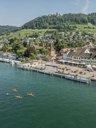 Four canoeists are on the Rhine in front of the old town in Stein am Rhein .