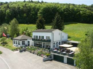Blick von oben auf das Restaurant Reiatstube mit Terrasse.
