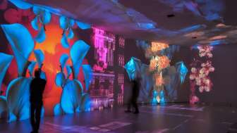 In one room, the walls, ceilings, and floors are illuminated by art.