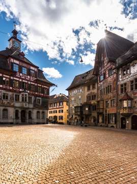 A view of the empty town hall square in Stein am Rhein. The building facades are decorated with medieval murals.