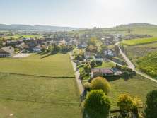 A small village surrounded by vines, meadows and fields.