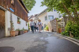 Guided tour of Hallau Group with a guide in a traditional costume walk through a small alley.