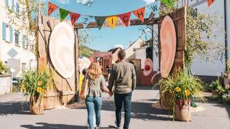 Wilchingen fall festival A couple holding hands. They walk through the colorfully decorated alleyways at the autumn festival in Wilchingen.