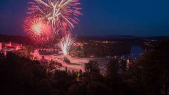 Red bursts of fireworks lit up the sky above the Rhine Falls.