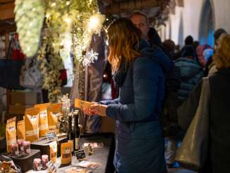 Schaffhausen Christmas market At a stand, a woman looks at a handmade product.