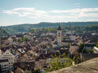 View over the rooftops of Schaffhausen's old town. A church tower rises up in the center.