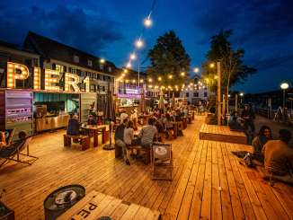 Rhykantine Schaffhausen A pop-up café and bar was set up on a wooden platform. The food is served from converted containers.