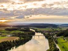 Rhine and landscape near Hemishofen from above during sunset. A bridge crosses the Rhine.
