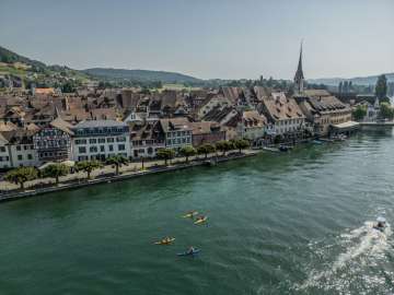 Canoe Stein am Rhein Three yellow and one blue canoe on the Rhine in front of the old town of Stein am Rhein.
