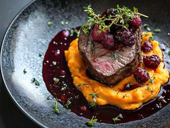 Game on a plate A piece of meat is arranged on a plate.