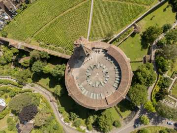 An aerial view of the round Munot fortress in Schaffhausen. Vineyards are visible on one side, and the Munot moat on the other.