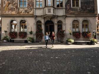 Town hall Stein am Rhein Two friends stand in front of the town hall in Stein am Rhein and look at the facade paintings.