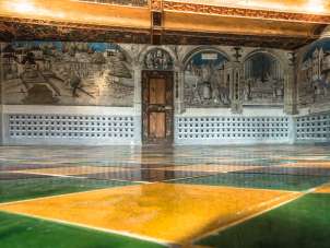 Room in the St. Georgen Museum in Stein am Rhein. Artistic drawings on the walls and a green, yellow and brown tiled floor